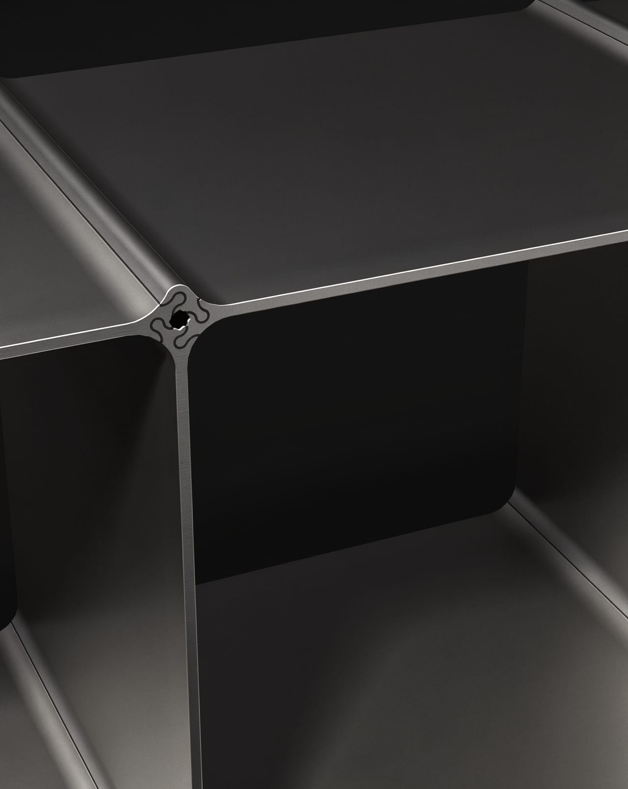 The slot connection up close: four profiles in black meet in the node around one hole, the seams between them stay visible
